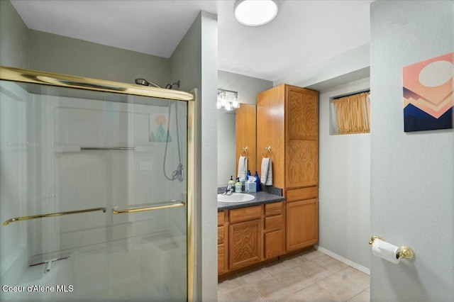 bathroom featuring tile patterned flooring, vanity, and walk in shower