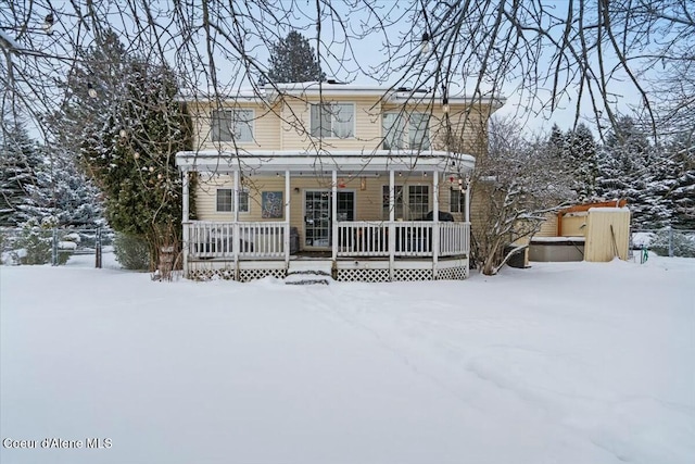 view of front of house with covered porch and a jacuzzi