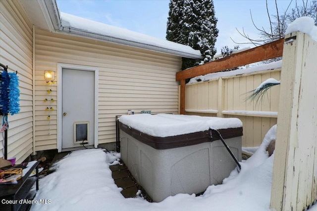 snow covered patio with a hot tub