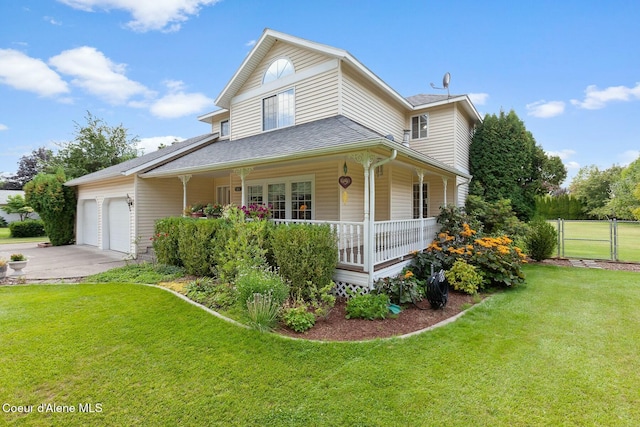 view of front of house with a garage, a front yard, and a porch