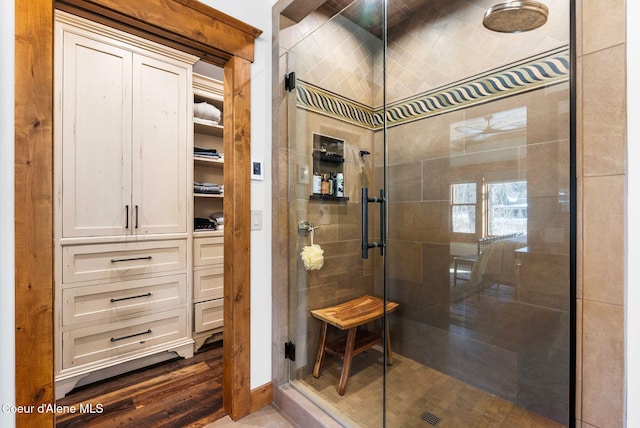 bathroom featuring hardwood / wood-style flooring and a shower with shower door