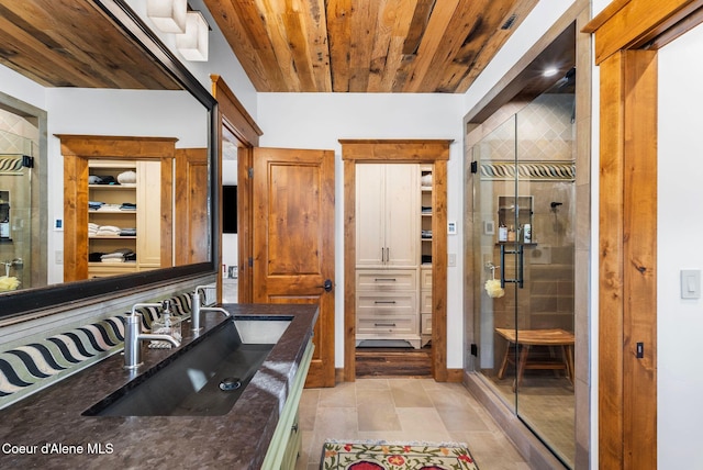 bathroom with wood ceiling, an enclosed shower, and vanity