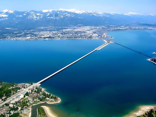 birds eye view of property with a water and mountain view