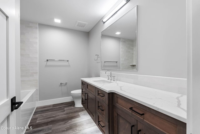 bathroom with vanity, hardwood / wood-style floors, and toilet