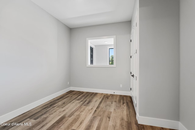 unfurnished room featuring hardwood / wood-style flooring