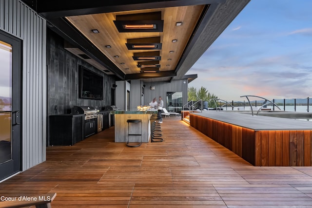 deck at dusk with a grill