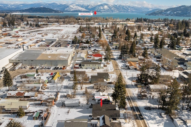 snowy aerial view featuring a mountain view