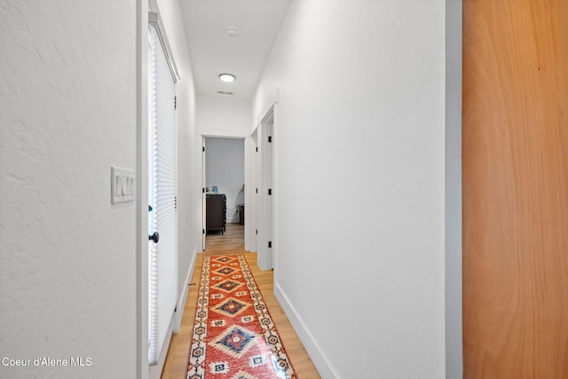 corridor featuring wood-type flooring