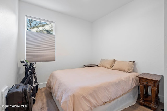 bedroom with hardwood / wood-style flooring