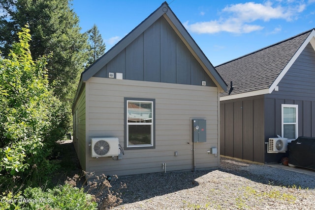 1224 Chestnut St, Sandpoint, ID 83864 - rear view of property with ac unit, roof with shingles, and board and batten siding