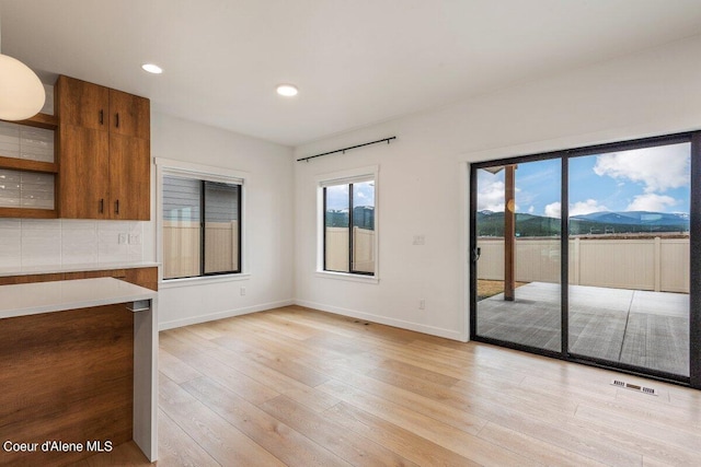 interior space with a mountain view and light wood-type flooring