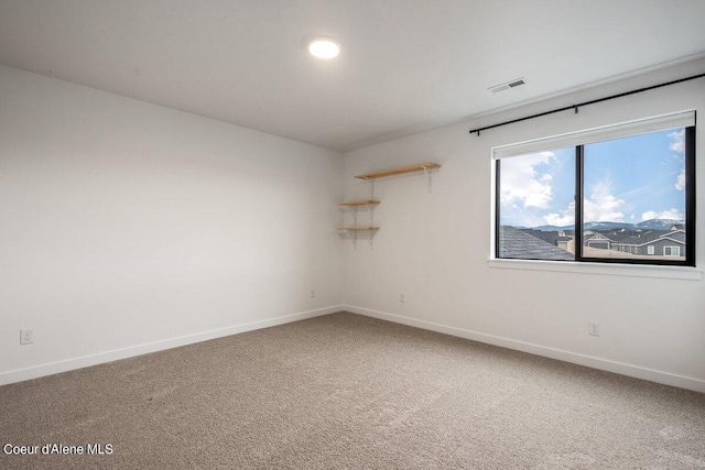 unfurnished room featuring carpet flooring