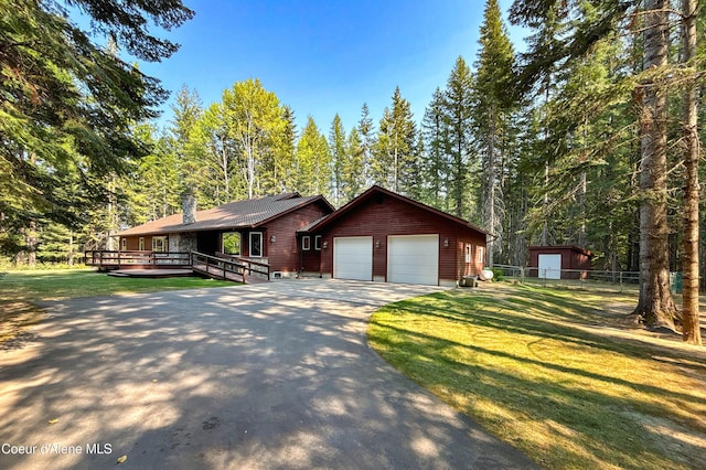 view of front of home with a wooden deck and a front lawn