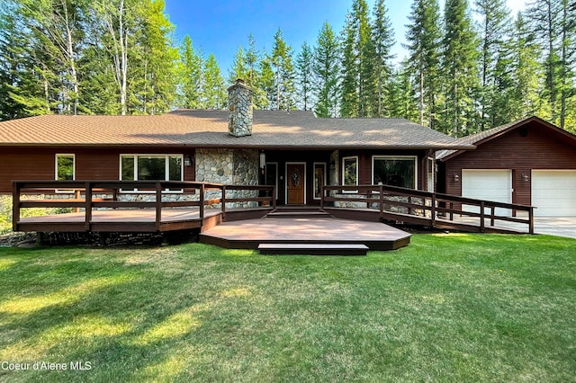 rear view of house with a wooden deck and a yard