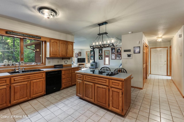 kitchen with pendant lighting, sink, light tile patterned floors, a center island, and black appliances