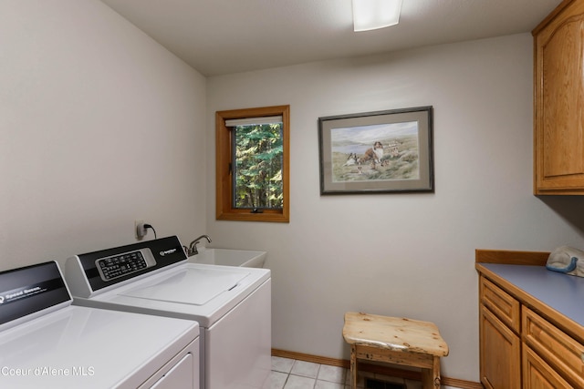 washroom with light tile patterned flooring, cabinets, sink, and washing machine and dryer