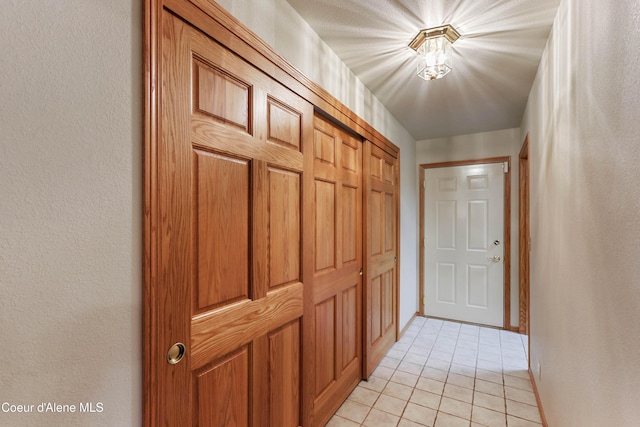 hall featuring light tile patterned floors
