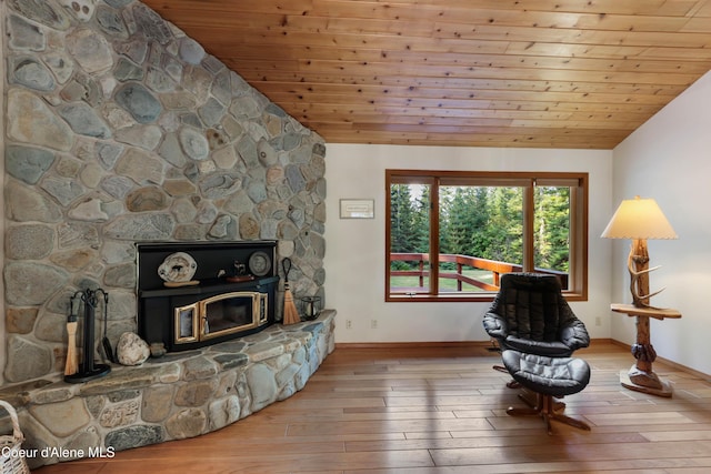 living area featuring wooden ceiling, vaulted ceiling, and light wood-type flooring