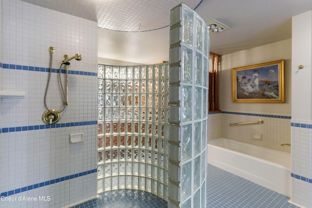 bathroom featuring tile patterned floors and shower with separate bathtub