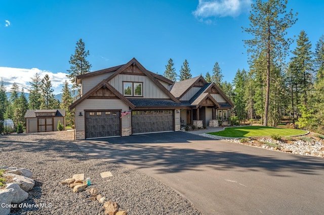 craftsman house with a garage and a storage shed