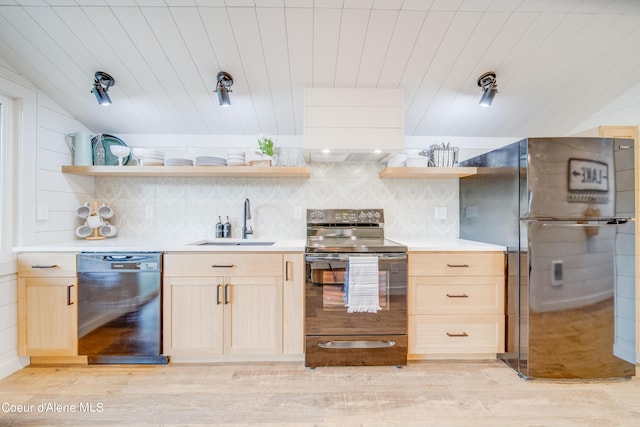 kitchen featuring light brown cabinetry, sink, tasteful backsplash, vaulted ceiling, and black appliances