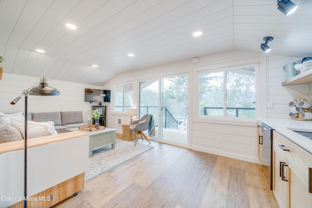 living room featuring wood ceiling, vaulted ceiling, light hardwood / wood-style flooring, and wood walls