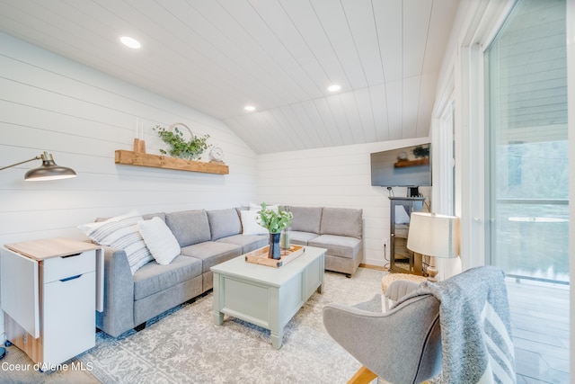 living room featuring lofted ceiling