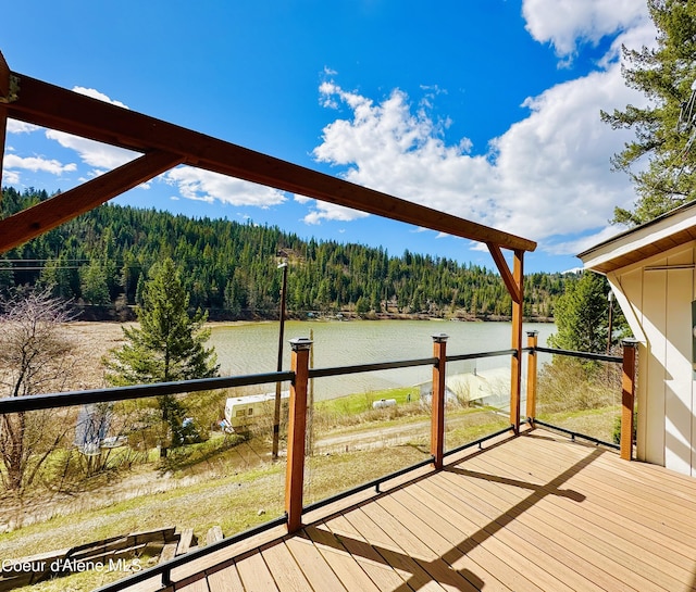 wooden terrace featuring a water view