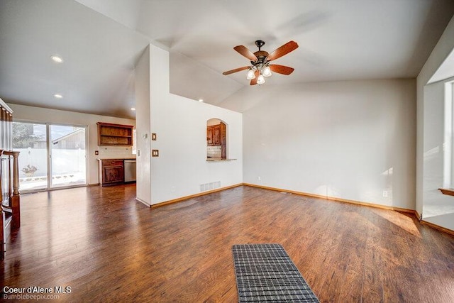 unfurnished living room featuring dark wood-type flooring, ceiling fan, and vaulted ceiling