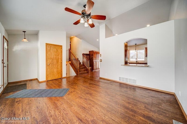 unfurnished living room featuring sink, hardwood / wood-style flooring, vaulted ceiling, and ceiling fan