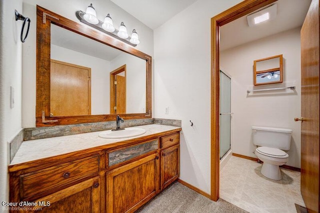 bathroom with vanity, toilet, and an enclosed shower