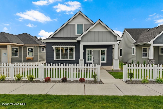 7148 N Bellac Ln, Coeur Dalene, ID 83815 - view of front facade with board and batten siding and a fenced front yard
