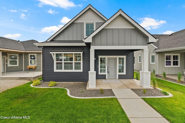 7148 N Bellac Ln, Coeur Dalene, ID 83815 - view of front of home with board and batten siding, a front lawn, and covered porch