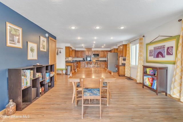 dining space with light hardwood / wood-style flooring