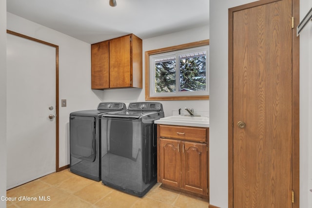 clothes washing area featuring cabinets, separate washer and dryer, and sink