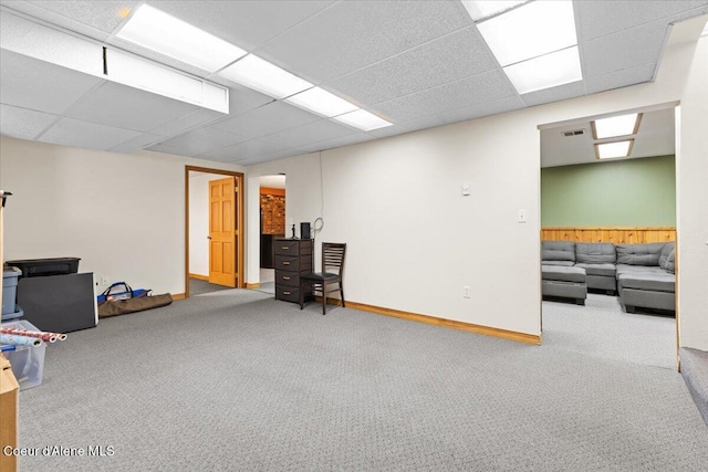 interior space featuring carpet floors, baseboards, visible vents, and a paneled ceiling