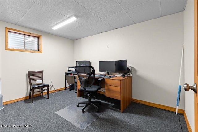 home office with carpet, a paneled ceiling, and baseboards