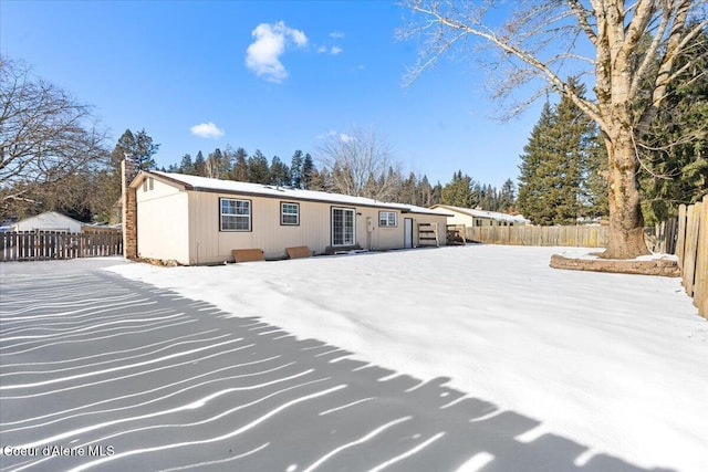 snow covered property featuring fence