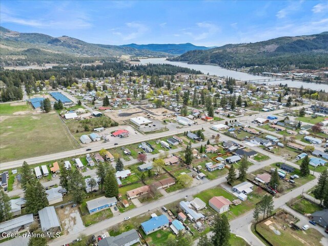 birds eye view of property with a water and mountain view
