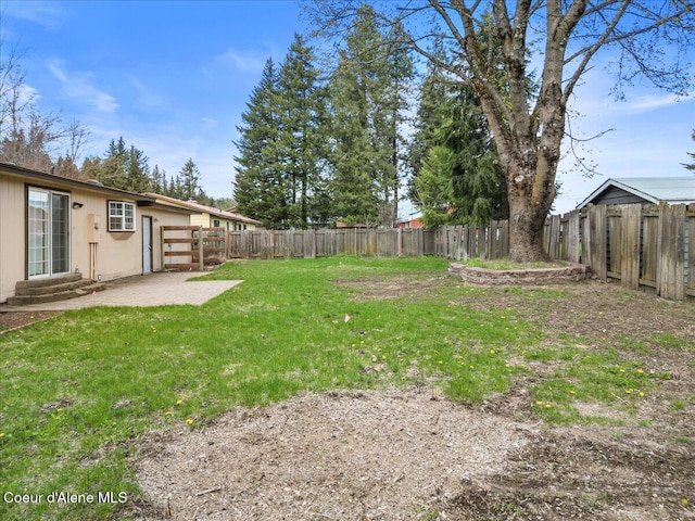 view of yard featuring a fenced backyard, entry steps, and a patio area