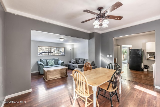 dining room with ceiling fan and dark hardwood / wood-style floors