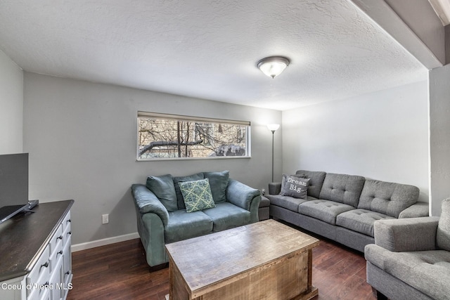 living room featuring dark hardwood / wood-style floors and a textured ceiling