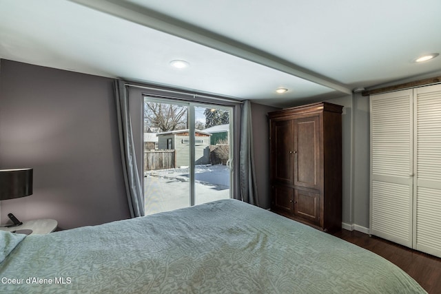 bedroom with access to exterior, a closet, and dark hardwood / wood-style floors