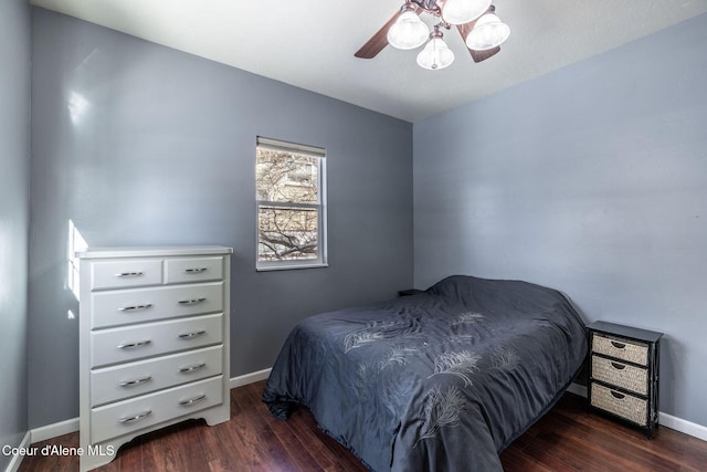 bedroom with dark hardwood / wood-style floors and ceiling fan