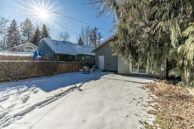 view of snow covered rear of property