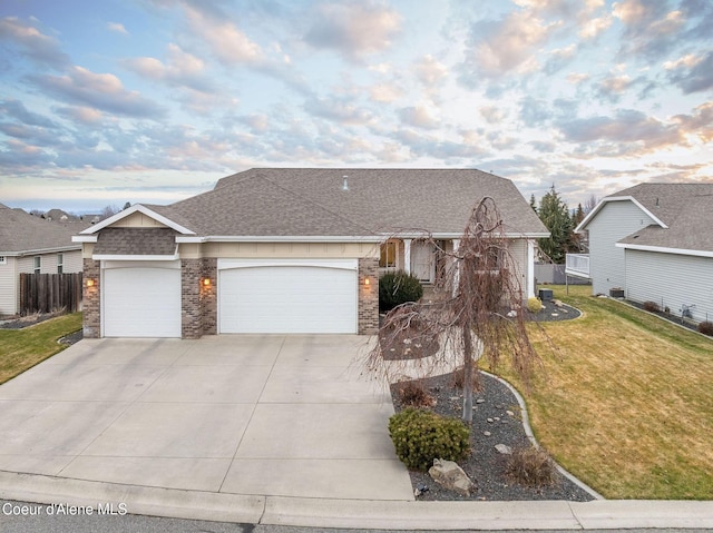 ranch-style home with a garage and a front yard