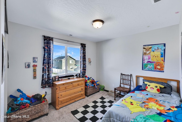 carpeted bedroom featuring a textured ceiling