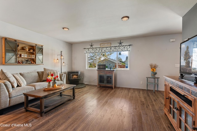 living room featuring dark hardwood / wood-style floors and a wood stove