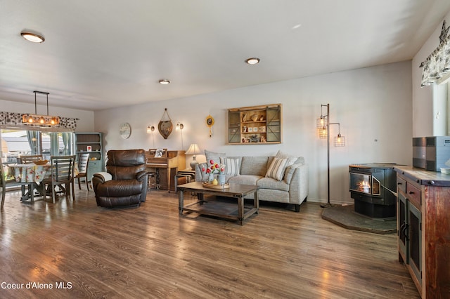 living room featuring dark wood-type flooring and a wood stove