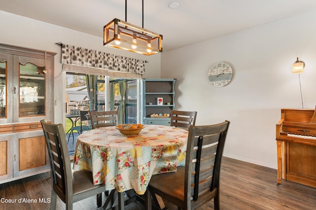 dining room with an inviting chandelier, dark hardwood / wood-style flooring, and french doors